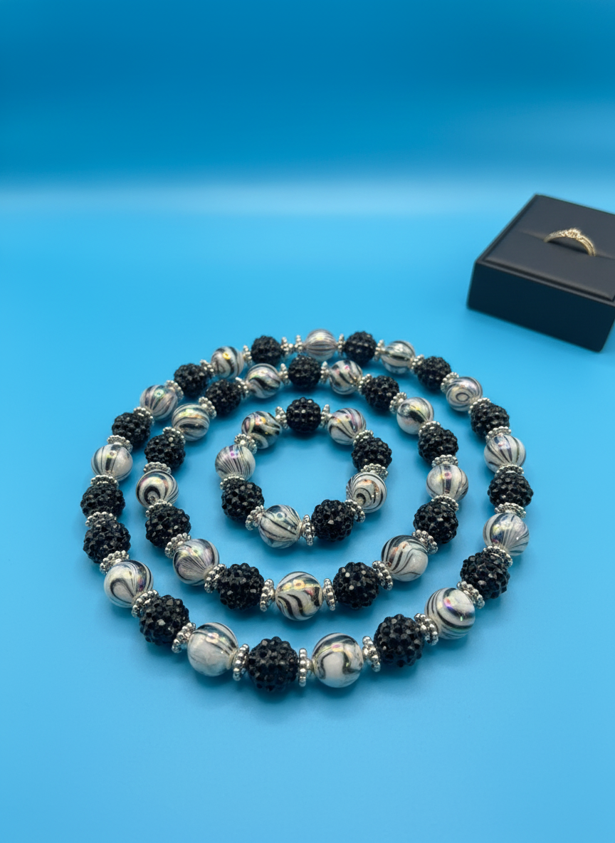 Midnight Whirl Necklace on blue background - shot 2